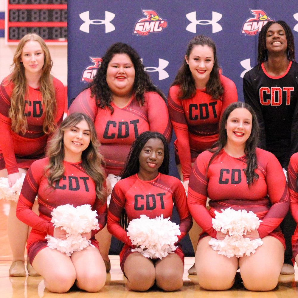 Group of cheerleaders in red uniforms with 'CDT' on a blue background featuring Under Armour logos.