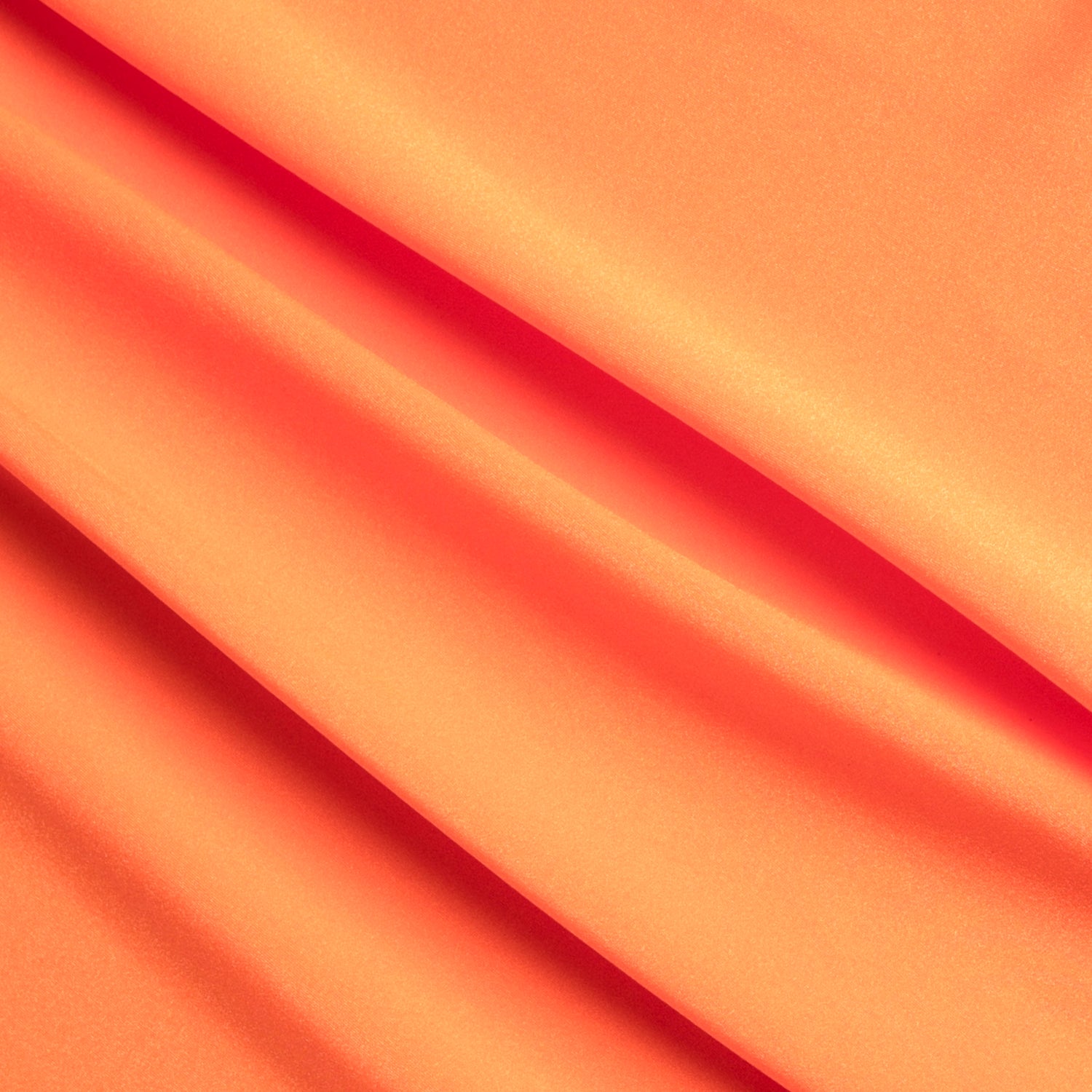 Close-up of orange fabric with folds